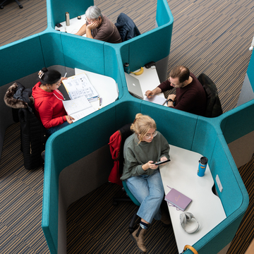 Students in enclosed silent area study spaces at Merchiston Library