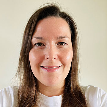 Staff headshot of Dawn Hamilton with brown hair and wearing a white t-shirt