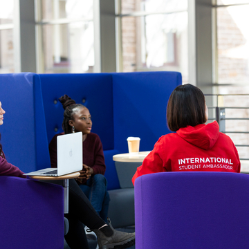 Students at Craiglockhart chatting, with laptop
