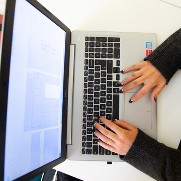 Student typing at laptop