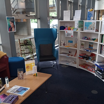 Image of the relaxation space at Craiglockhart Library, with comfortable seating and bookshelves with games
