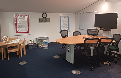 Image of Craiglockhart Family Room, with table chairs and screen plus small table and chairs for children.