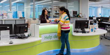Student and Library staff member talking at Sighthill LRC help desk