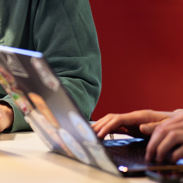 Close up of students hands at the work at a laptop
