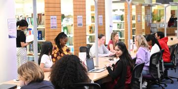 Students working together at a desk in Craiglockhart Library