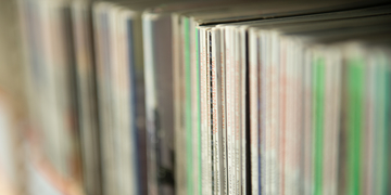 Close up of journals standing on library shelves