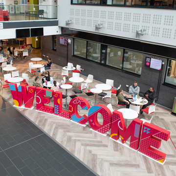 Patterned red 'Welcome' letters in canteen area at Sighthill campus