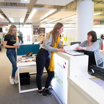 Student talking to staff at iPoint desk