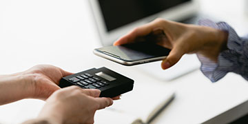 A payment being made via a mobile phone to a portable card reader