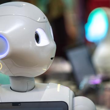 A close-up of a humanoid robot with its head turned to the side