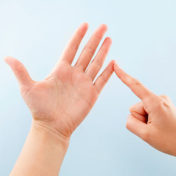 A pair of hands spelling out the letter U in British Sign Language