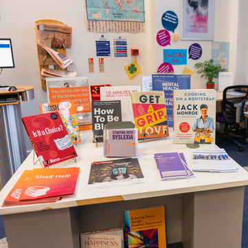 A table with a selection of books from the library's wellbeing collection