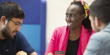 A small group of students in conversation with each other over coffee