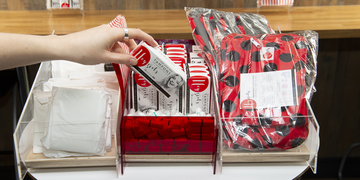 Student taking free period products from dispenser