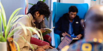 Students sitting studying and reading books