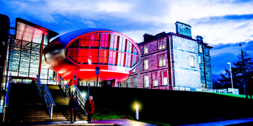 Craiglockhart campus lit up with red lighting at night