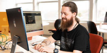 Student working at a computer in a bright room