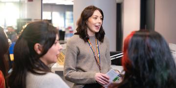 Student ambassadors talking to other students in open area on campus