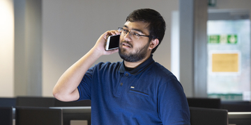 A lone student speaking on a mobile phone