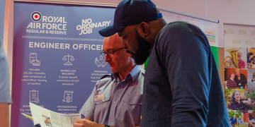 Student talking to Royal Air Force worker at a stall
