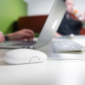 Close up of computer mouse and laptop