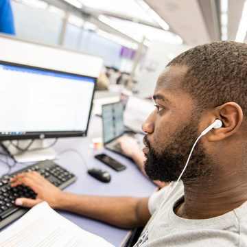 Student with headphones in working at computer
