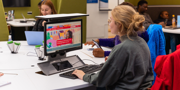 Student using a computer in the JKCC at Merchiston