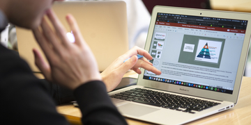 Student typing on a laptop