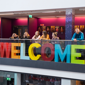Welcome sign and students at Sighthill campus