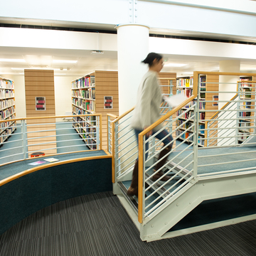 Person walking up stairs in Merchiston Library