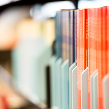 Spines of periodicals on a bookshelf 