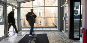 Student walking through entrance at Merchiston campus