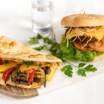 A chicken burger and flatbread with vegetable dressing