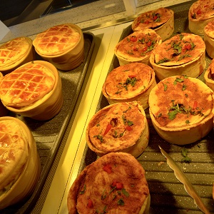 A selection of pies sitting on the hot plate