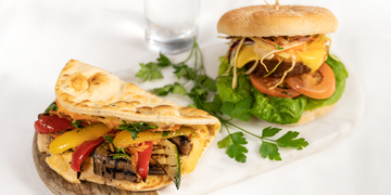 A chicken burger and flatbread with vegetable dressing