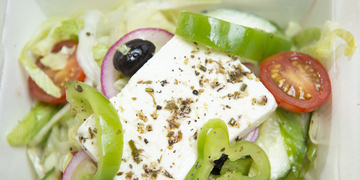 Close-up of salad items, including tomatoes, feta cheese, lettuce and cucumber