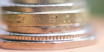 Close-up photograph of a stack of pound coins