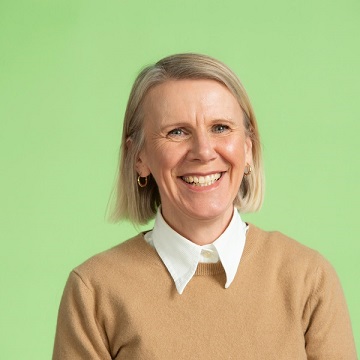 Staff headshot of Jane Barclay with short blonde hair, wearing a tan jumper and light shirt.