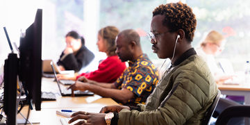 A group of students studying in a row of computers